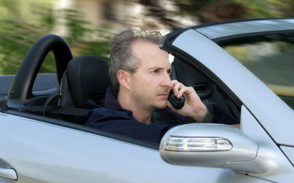 Driver using mobile phone at the wheel