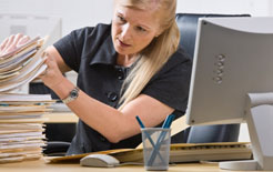 Company secretary struggles with a pile of paperwork