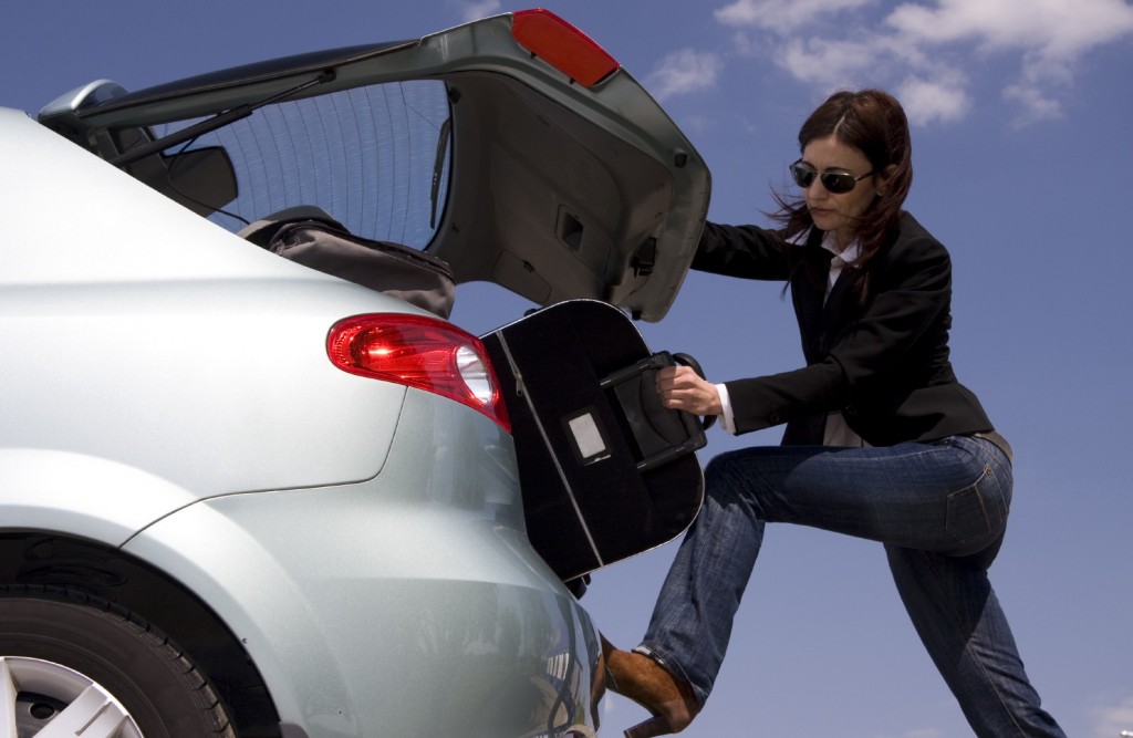 Best estate car award - woman forcing cases into back of car