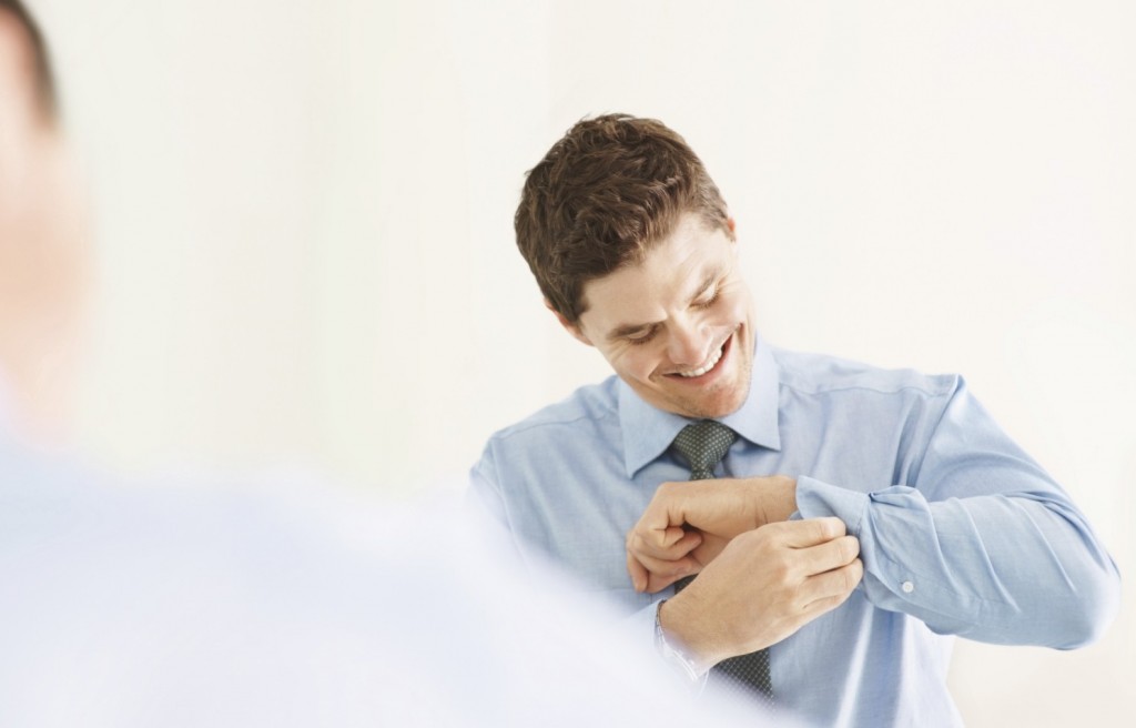 iStock_000011436378Medium Smart young executive getting dressed for work