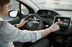 Company car driver using Peugeot 208 colour touchscreen