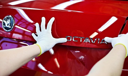 Skoda Octavia badge being applied on the production line