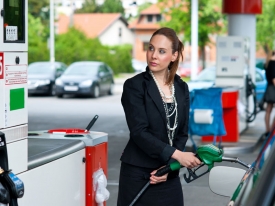 Businesswoman fills up her company car with fuel