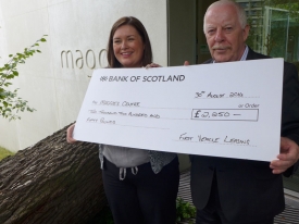 Dixie Deans of First Vehicle Leasing, former Celtic FC footballer, presents a £2,250 cheque to Tricia Imrie, Centre Fundraising Manager, Maggie’s Glasgow