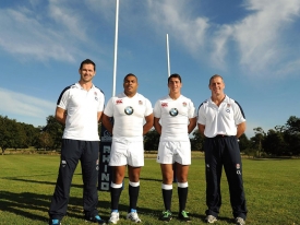 England rugby head coach Stuart Lancaster (R) poses with backs coach Andy Farrell (L) and Academy players (2L-2R) Kyle Sinckler and Brett Herron during the launch of the BMW Performance Academy at Wokefield Park on September 25, 2012 in Reading, England.