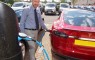 Jim Hannah recharges the Tesla Model S