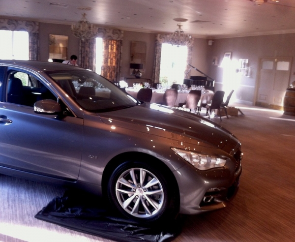 Infiniti Q50 diesel in the foreground as the dinner table is prepared