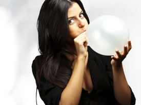 Close up of woman blowing up balloon