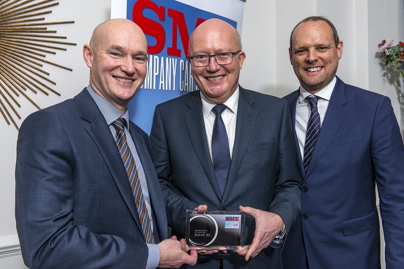 Jaguar's Jon Wackett, centrre, receives the SME Company Car of the Year Award from David Blackmore, left, commercial director of Fleet Alliance, and Paul Hollick, managing director TMC, who chaired the judging panel