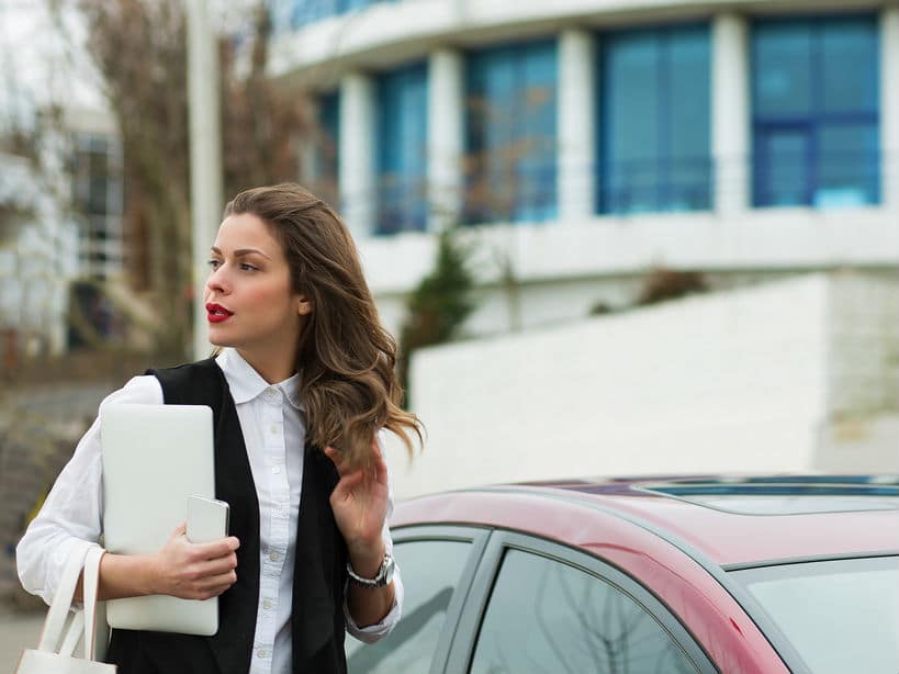Business woman with a car bought on car finance